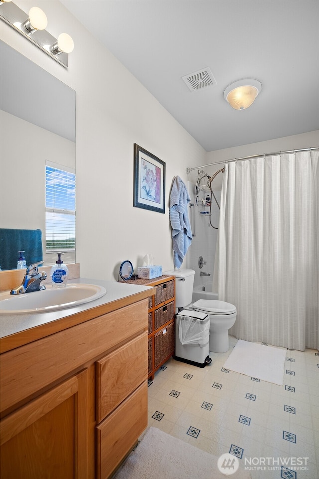 1810 Johnson Ave, Dupont, WA 98327 - bathroom featuring vanity, shower / bath combo, toilet, and visible vents