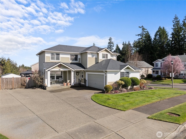 1810 Johnson Ave, Dupont, WA 98327 - traditional-style home featuring fence, covered porch, a front yard, an attached garage, and driveway