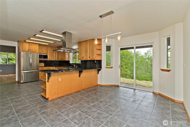 511 104th Ln SE, Olympia, WA 98501 - kitchen with island exhaust hood, appliances with stainless steel finishes, open shelves, dark countertops, and a peninsula
