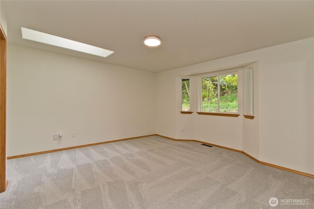 511 104th Ln SE, Olympia, WA 98501 - empty room with light colored carpet, baseboards, and a skylight