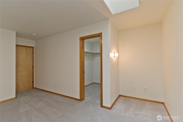 511 104th Ln SE, Olympia, WA 98501 - unfurnished bedroom featuring light carpet, baseboards, a walk in closet, and a closet