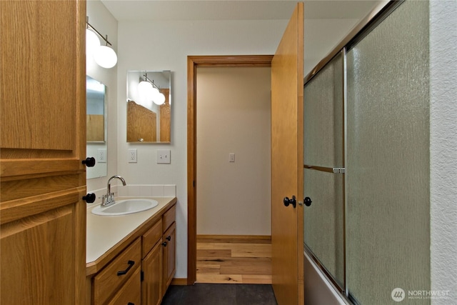511 104th Ln SE, Olympia, WA 98501 - bathroom featuring vanity, enclosed tub / shower combo, and wood finished floors