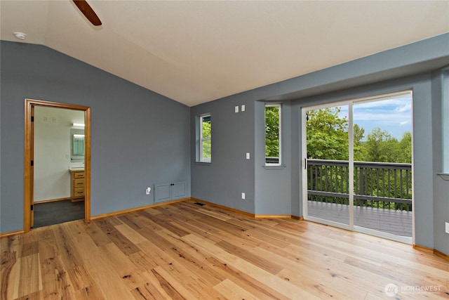 511 104th Ln SE, Olympia, WA 98501 - unfurnished living room featuring lofted ceiling, light wood-style flooring, baseboards, and a ceiling fan