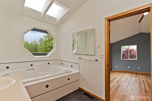 511 104th Ln SE, Olympia, WA 98501 - full bathroom featuring vaulted ceiling, wood finished floors, and baseboards