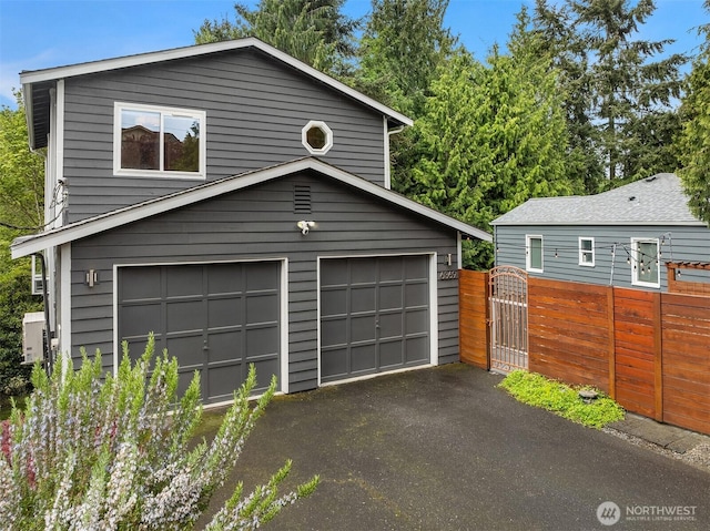 6369 23rd Ave SW, Seattle, WA 98106 - garage featuring driveway, fence, and a gate