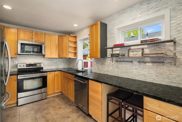 6369 23rd Ave SW, Seattle, WA 98106 - kitchen with open shelves, appliances with stainless steel finishes, a sink, dark stone countertops, and backsplash