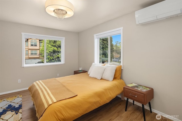 6369 23rd Ave SW, Seattle, WA 98106 - bedroom featuring baseboards, a wall mounted AC, and wood finished floors
