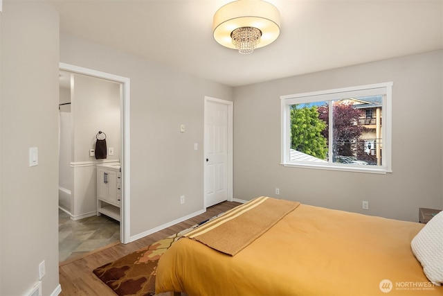 6369 23rd Ave SW, Seattle, WA 98106 - bedroom featuring baseboards, ensuite bath, and wood finished floors