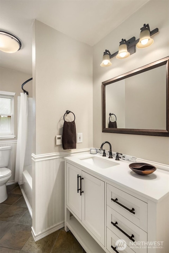 6369 23rd Ave SW, Seattle, WA 98106 - full bathroom with tile patterned flooring, shower / bath combo, vanity, a wainscoted wall, and toilet