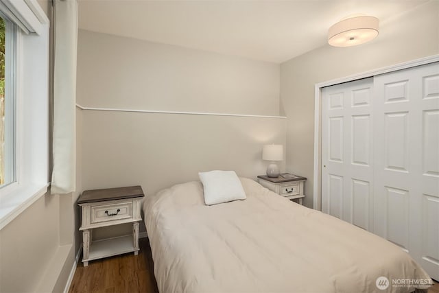 6369 23rd Ave SW, Seattle, WA 98106 - bedroom with baseboards, a closet, and dark wood-style flooring