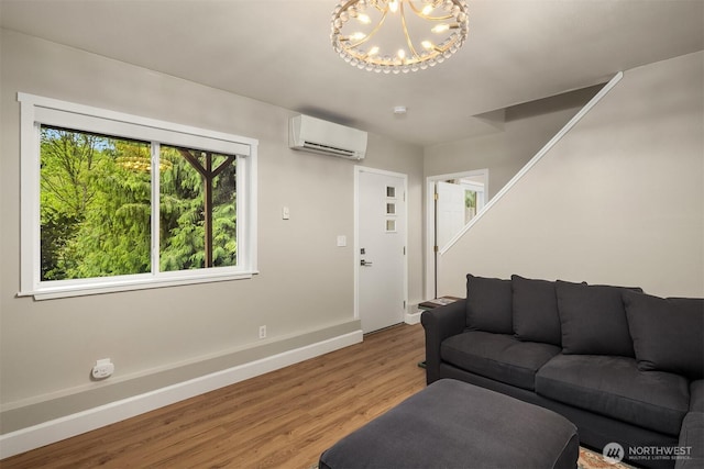 6369 23rd Ave SW, Seattle, WA 98106 - living room featuring baseboards, a notable chandelier, a wall unit AC, and wood finished floors