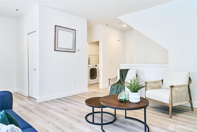 sitting room with baseboards, recessed lighting, light wood finished floors, and washing machine and clothes dryer