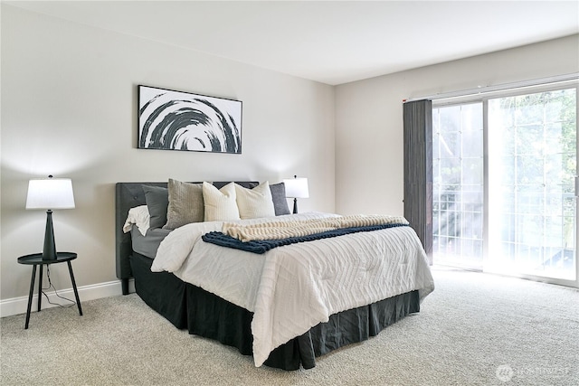 bedroom with access to outside, baseboards, and carpet