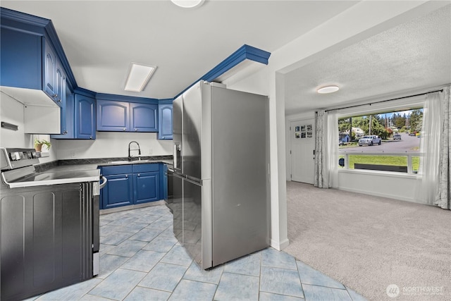 5808 241st St SW, Mountlake Terrace, WA 98036 - kitchen with dark countertops, a sink, stainless steel refrigerator with ice dispenser, range with electric stovetop, and blue cabinets