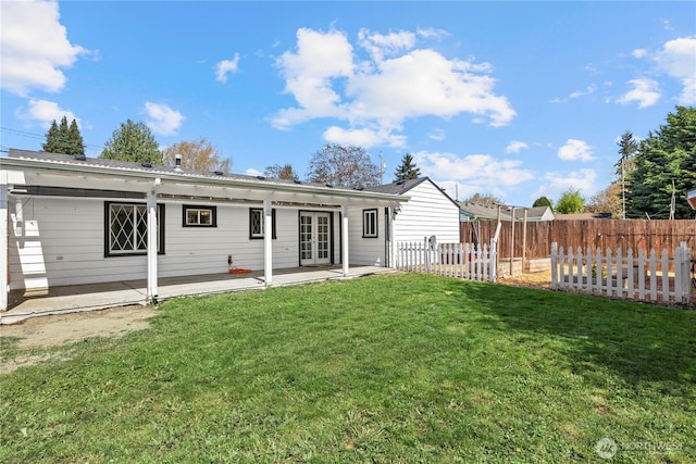 5808 241st St SW, Mountlake Terrace, WA 98036 - back of property with a lawn, a patio, fence, and french doors
