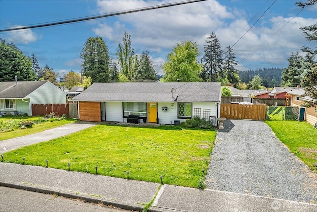 5808 241st St SW, Mountlake Terrace, WA 98036 - ranch-style house with fence, an attached garage, driveway, and a front yard