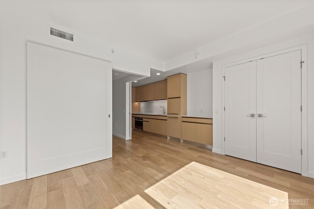 unfurnished living room featuring light wood-type flooring, recessed lighting, and baseboards