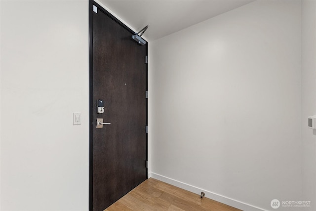 doorway to outside featuring light wood-type flooring and baseboards