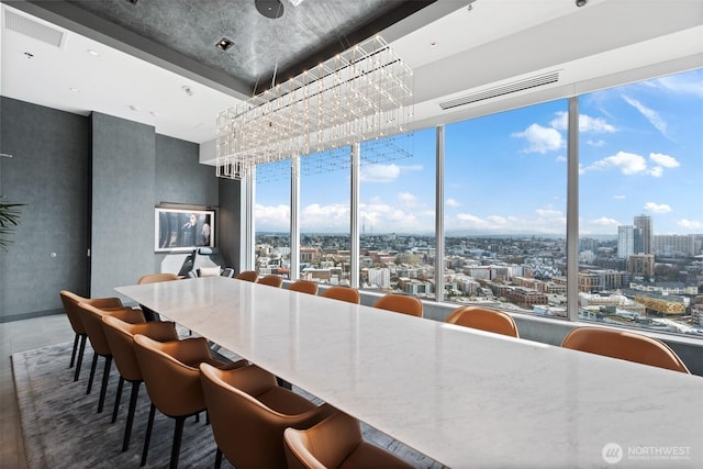 dining area with a view of city and a wall of windows