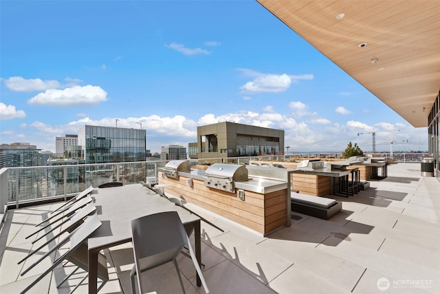 view of patio / terrace featuring area for grilling and a view of city