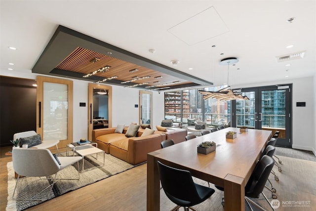 dining room featuring light wood-style floors, french doors, and recessed lighting