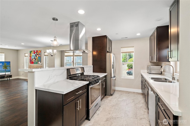 kitchen with stainless steel appliances, ventilation hood, a sink, dark brown cabinets, and baseboards