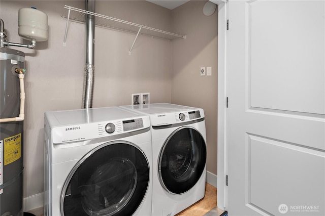 laundry area featuring washer and dryer and strapped water heater