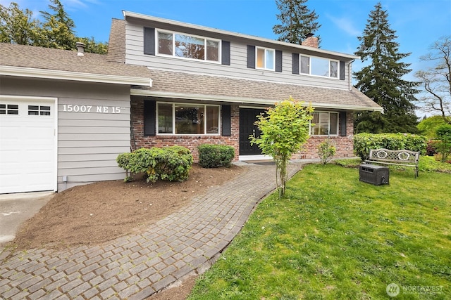 traditional home with a front lawn, roof with shingles, a chimney, brick siding, and an attached garage