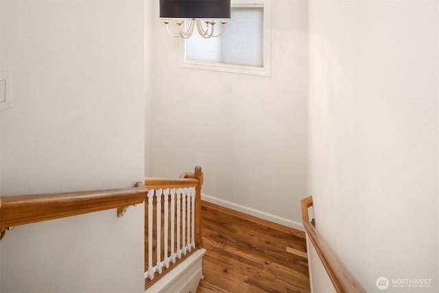 stairs featuring baseboards and wood finished floors