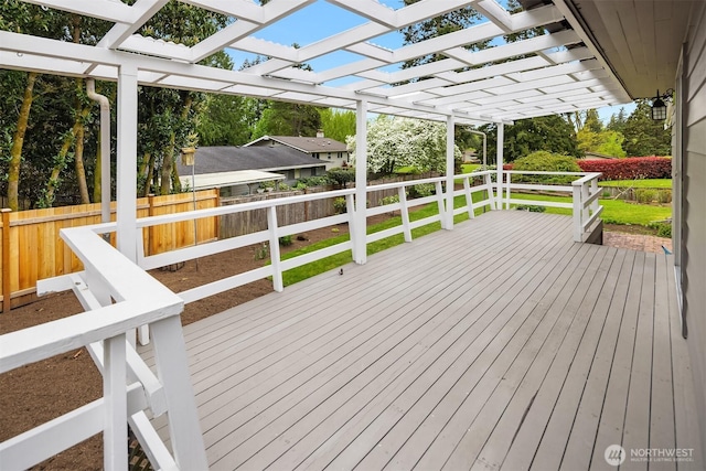 deck with a pergola and a fenced backyard