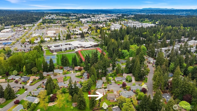 aerial view featuring a view of trees and a mountain view