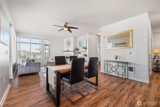 dining room with baseboards, a ceiling fan, and wood finished floors