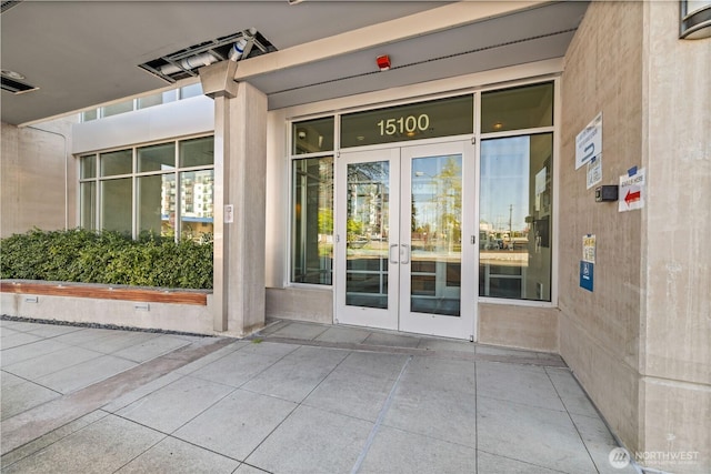 view of exterior entry featuring french doors and visible vents