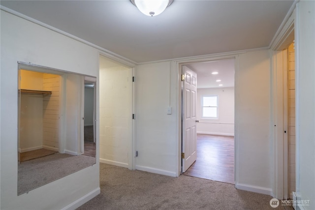 hall featuring carpet floors and baseboards