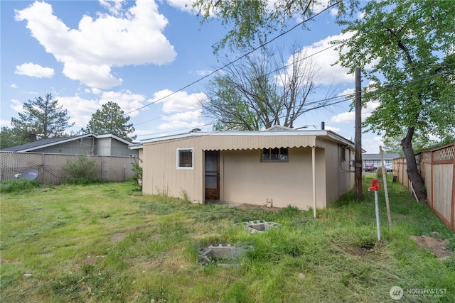 exterior space featuring a fenced backyard and a yard