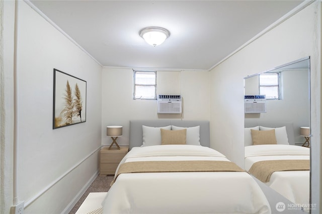 bedroom with baseboards and a wall mounted air conditioner