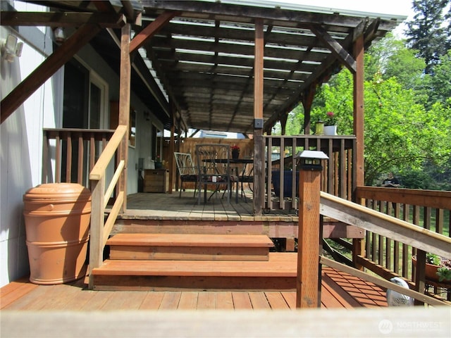wooden terrace with outdoor dining space