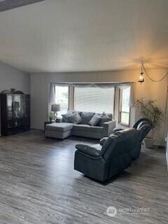 living room featuring wood finished floors and lofted ceiling