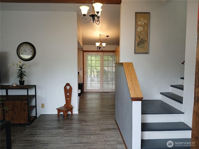 foyer entrance featuring a chandelier, wood finished floors, and stairs