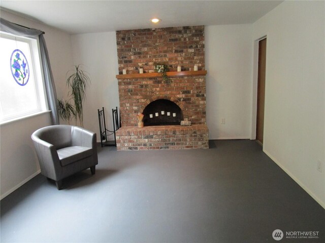 living area with a brick fireplace, baseboards, and recessed lighting