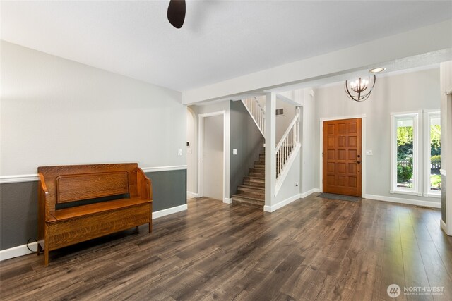 entryway with stairs, baseboards, wood finished floors, and ceiling fan with notable chandelier