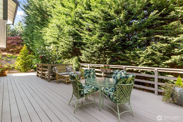 wooden deck featuring outdoor dining area