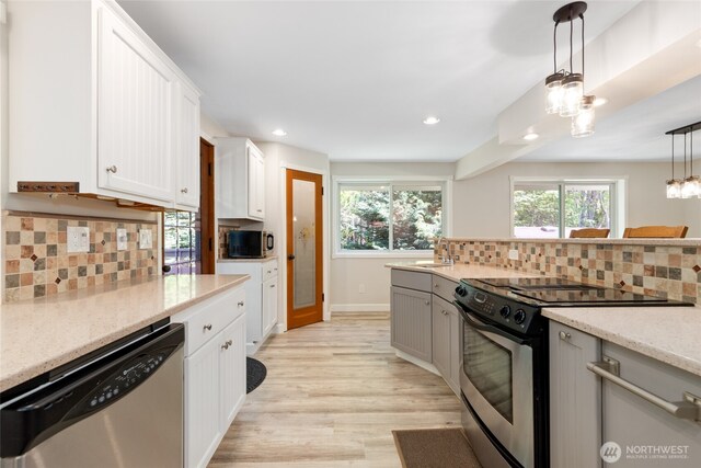 kitchen featuring backsplash, recessed lighting, appliances with stainless steel finishes, and a sink