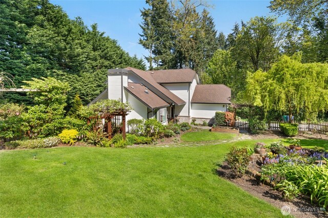 exterior space featuring a lawn and fence