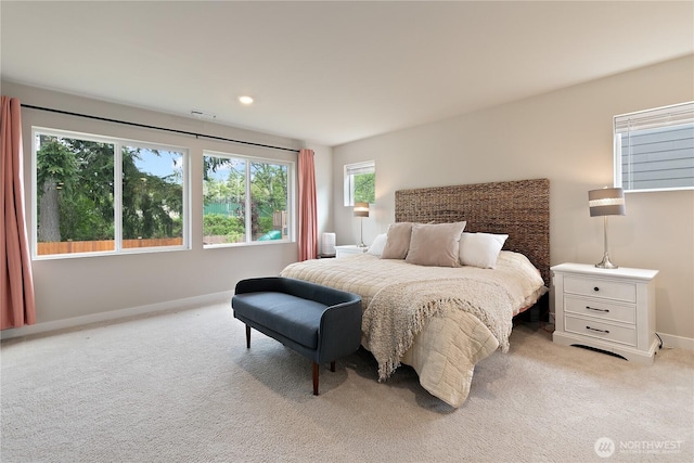 bedroom with light colored carpet, baseboards, and visible vents