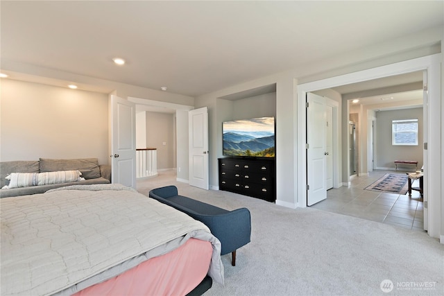 bedroom featuring recessed lighting, baseboards, light colored carpet, and light tile patterned floors