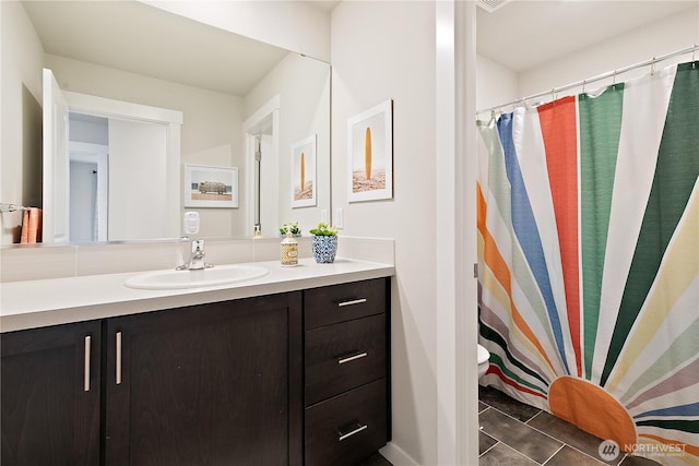 full bathroom with vanity and tile patterned flooring