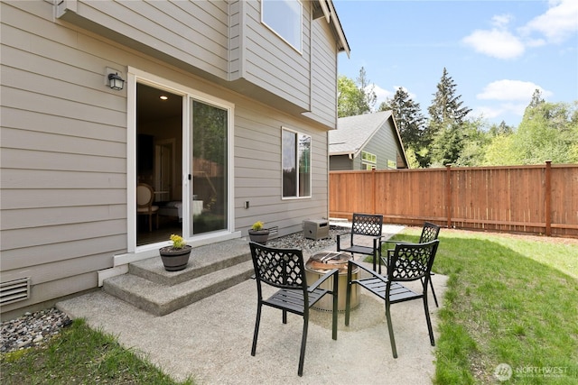 view of patio with fence and visible vents
