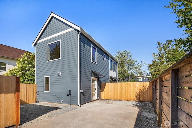 back of house featuring a fenced backyard and a patio area