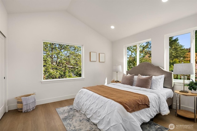 bedroom featuring recessed lighting, baseboards, lofted ceiling, and wood finished floors